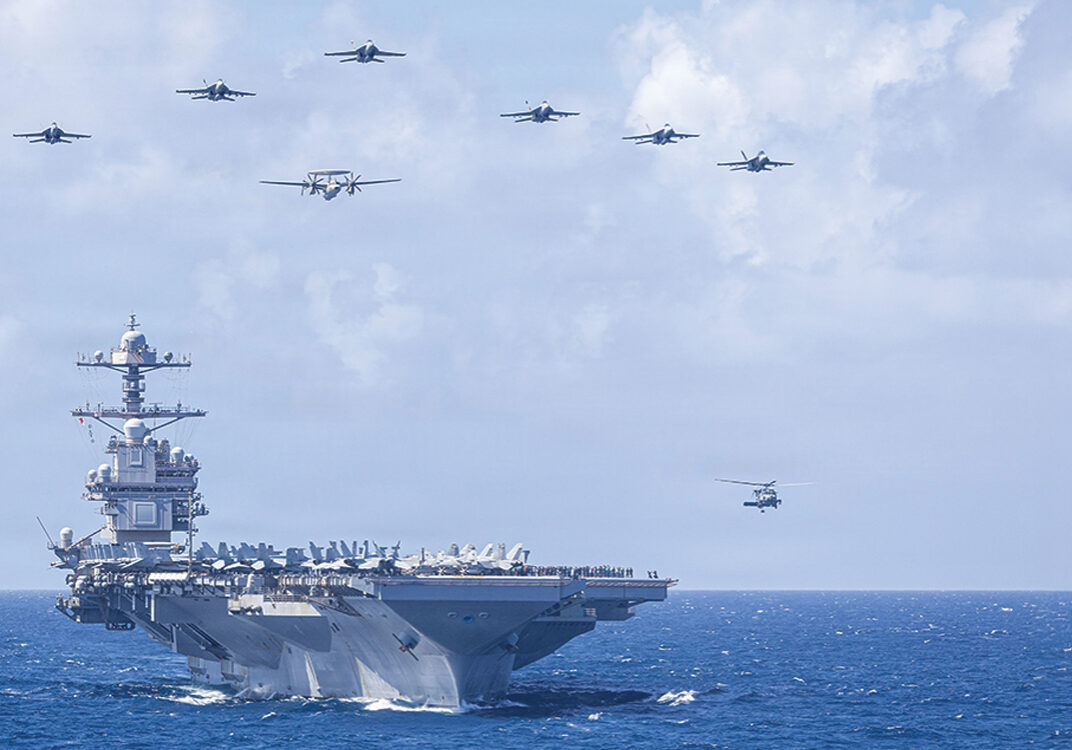 U.S. Navy Carrier Air Wing 8 aircraft fly in formation over the world’s largest aircraft carrier, Ford-class aircraft carrier USS Gerald R. Ford (CVN 78), during Carrier Air Wing 8’s aerial change of command ceremony while underway in the Caribbean Sea, Jan. 19, 2026. U.S. military forces are deployed to the Caribbean in support of the U.S. Southern Command mission, Department of War-directed operations, and the president’s priorities to disrupt illicit drug trafficking and protect the homeland. (U.S. Navy photo)